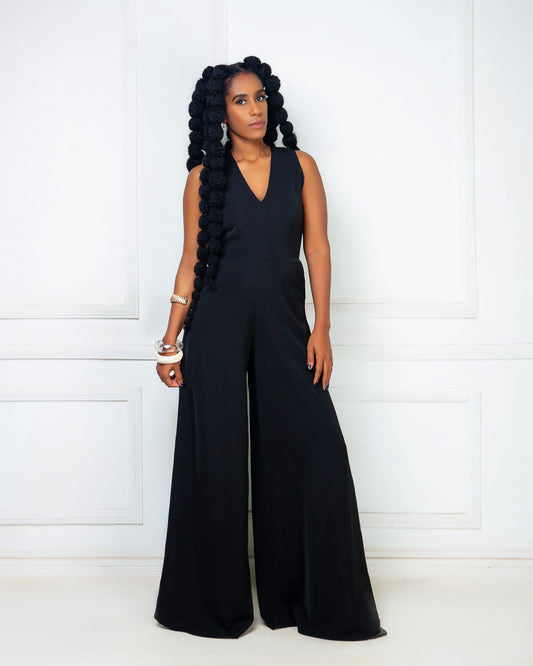Woman wearing a black sleeveless wide leg jumpsuit