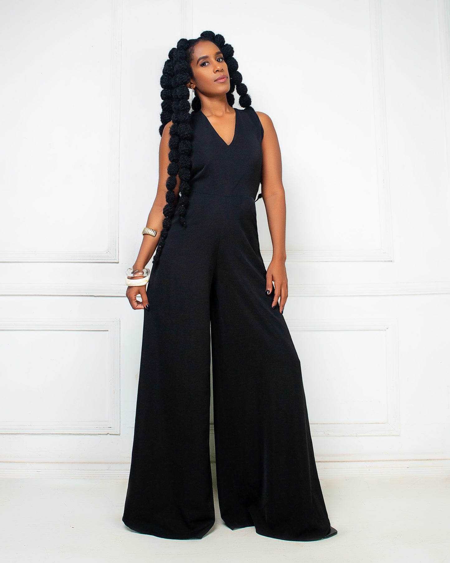 Woman wearing a black sleeveless wide leg jumpsuit