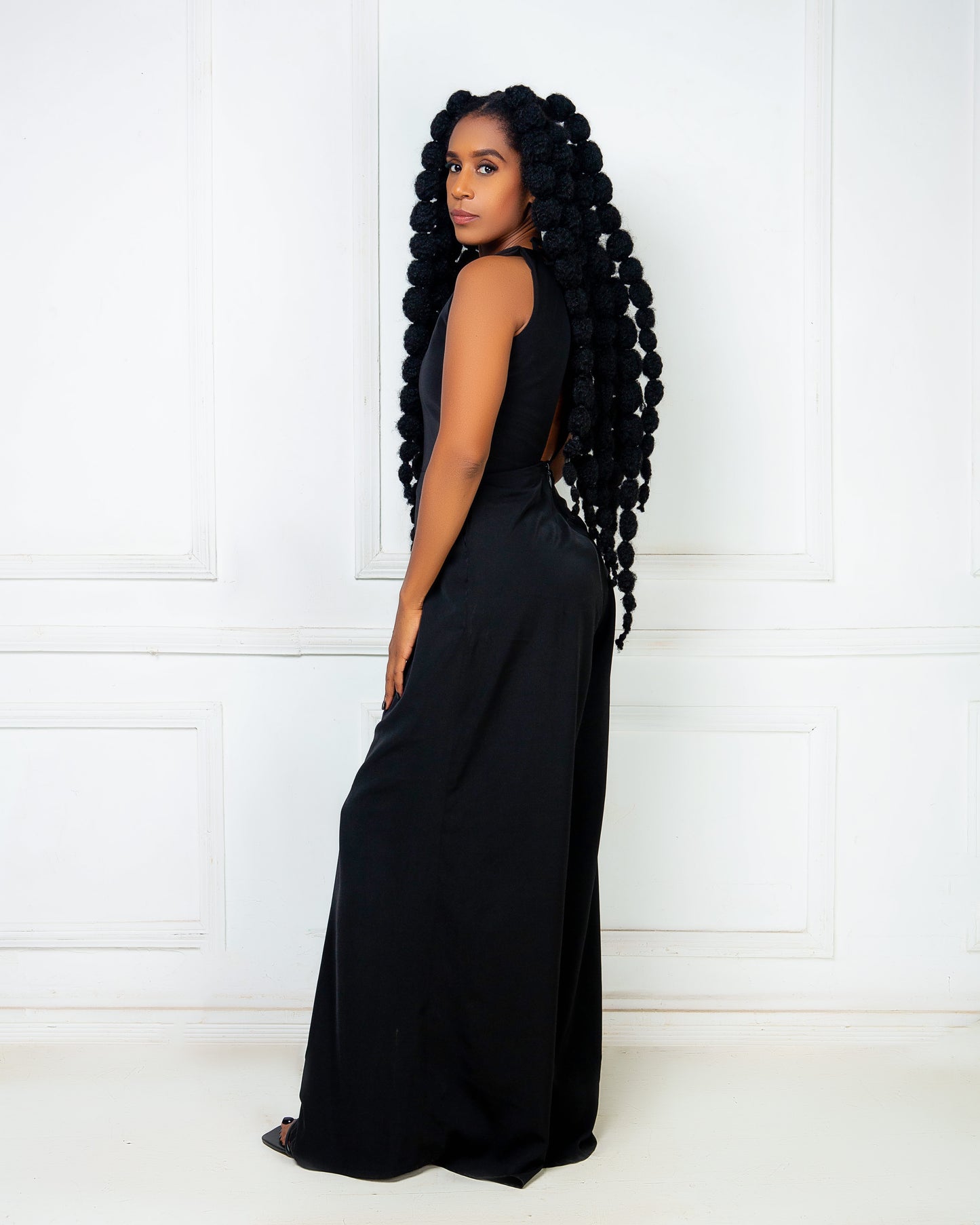 Woman wearing a black sleeveless wide leg jumpsuit